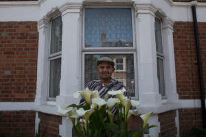 Portrait of man at bay window