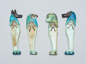 The four sons of Horus amulets. Pictured from left to right: Duamutef (ECM 1593), Qebehsenuef (ECM 1594), Imseti (ECM 1595), and Hapi (ECM 1596). © Eton Myers Collection, Research and Collection Collections, University of Birmingham
