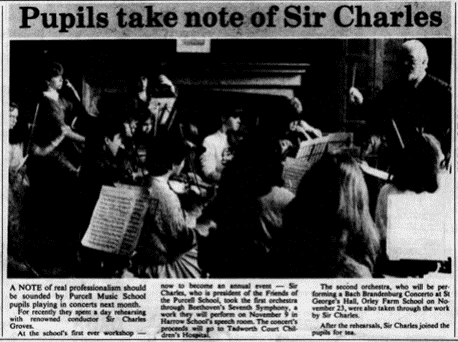 A newspaper clipping, titled "Pupils take note of Sir Charles". Below the title is a black and white image of children playing instruments and reading sheet music in front of a conductor. The text below describes the event. In sum, Purcell Music School pupils rehearsed with Sir Charles Groves for their upcoming concerts. This was to become an annual event. Sir Charles led the first orchestra through Beethoven's Seventh Symphony, and the children were performing this at an event in November to raise money for Tadworth Court Children's Hospital. The second orchestra, also led by Sir Charles were performing Bach's Brandenburg Concerto later in November. Both groups were joined by Sir Charles for tea after the rehearsals.