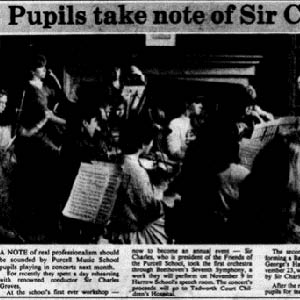 A newspaper clipping, titled "Pupils take note of Sir Charles". Below the title is a black and white image of children playing instruments and reading sheet music in front of a conductor. The text below describes the event. In sum, Purcell Music School pupils rehearsed with Sir Charles Groves for their upcoming concerts. This was to become an annual event. Sir Charles led the first orchestra through Beethoven's Seventh Symphony, and the children were performing this at an event in November to raise money for Tadworth Court Children's Hospital. The second orchestra, also led by Sir Charles were performing Bach's Brandenburg Concerto later in November. Both groups were joined by Sir Charles for tea after the rehearsals.