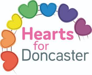 The Hearts for Doncaster logo. The text: “Hearts for Doncaster” is surrounded by drawings of seven cartoon hearts, each a different colour of the rainbow.