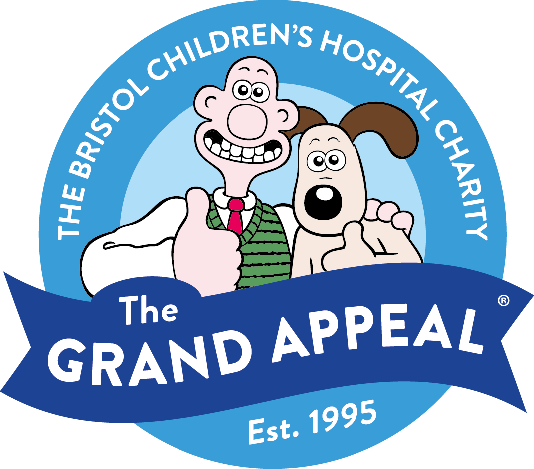An image of The Grand Appeal logo featuring popular British animated characters Wallace and Gromit (a man and a dog) both giving a thumbs up. Wallace (the man) has his arm around Gromit's (the dog) shoulder. The logo is round with the two characters in a blue circle. The text around the outside reads "The Bristol Children's Hospital Charity, The Grand Appeal, Est. 1995".