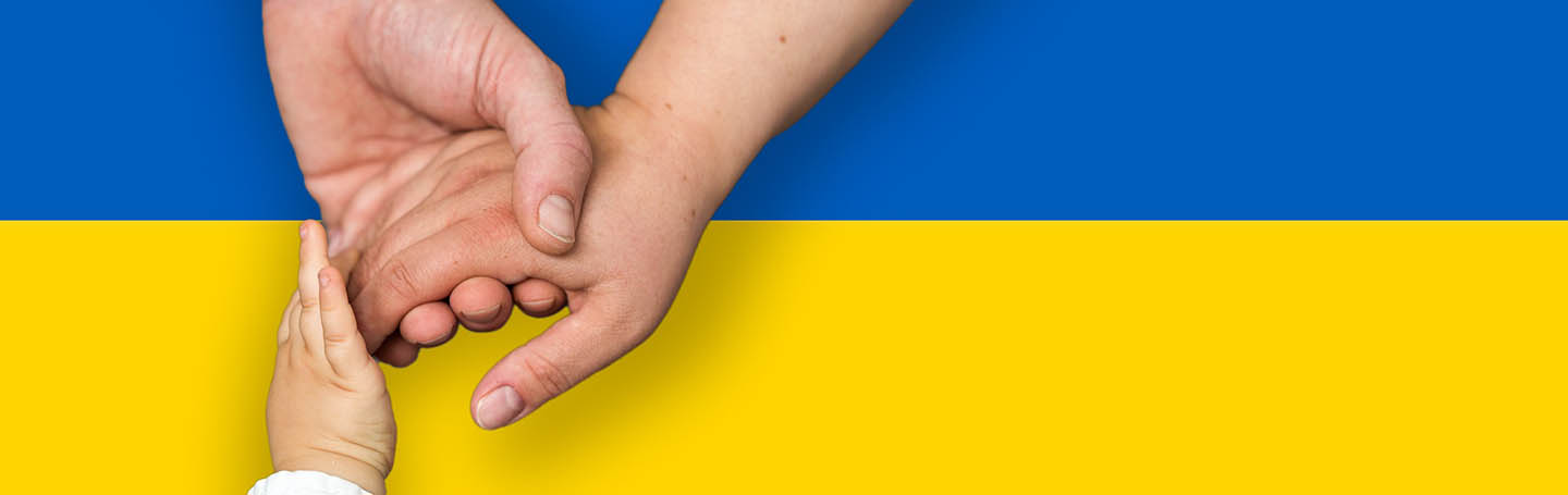 Peoples hands resting on the Ukraine flag