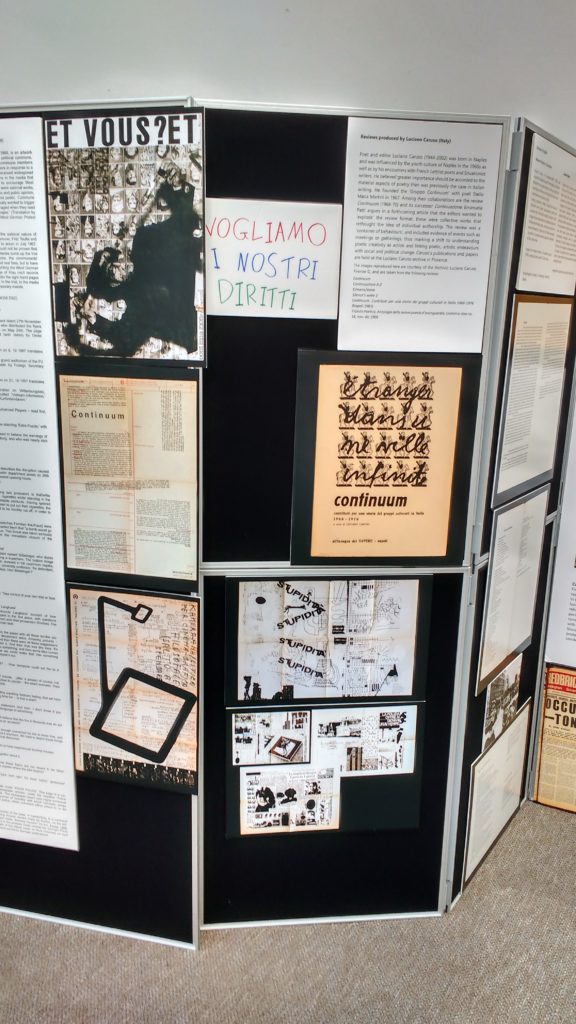 A vertical display board showing black and white images and texts.