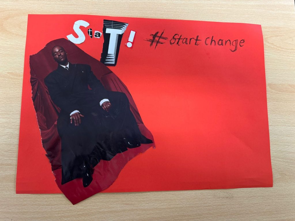 The word START! is assembled in collage letters at the top of a red poster paper, and #startchange is handwritten beside this. A cut-out image of actor Ncuti Gatwa is pasted to the left of the poster, with a blank red space in the right hand side of the poster.